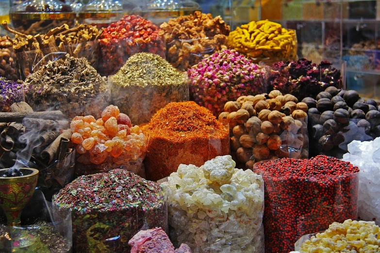 a display case filled with lots of different types of candies, a picture, by Edward Ben Avram, pexels, renaissance, inside an arabian market bazaar, spices, grain”