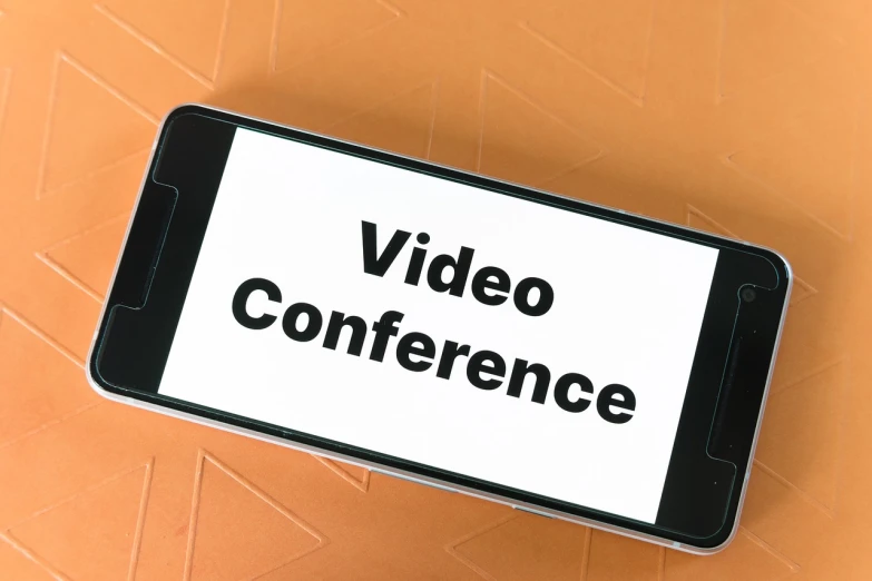 a cell phone with the words video conference on it, by Whitney Sherman, shutterstock, 4k footage, long table, press conference, 2 0 2 2 photo