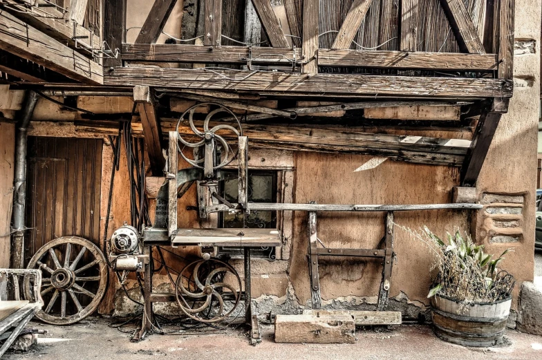 an old machine sitting in front of a building, a portrait, inspired by Rube Goldberg, pexels contest winner, assemblage, medieval cottage interior, saws, old shops, detailed studio photograph