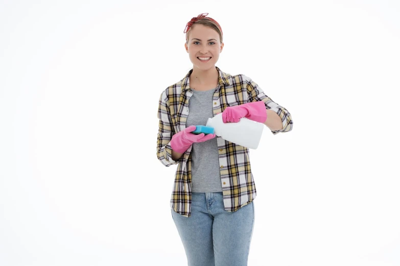 a woman in plaid shirt holding a spray bottle, a photo, shutterstock, plasticien, clean white background, white and pink cloth, very sharp photo