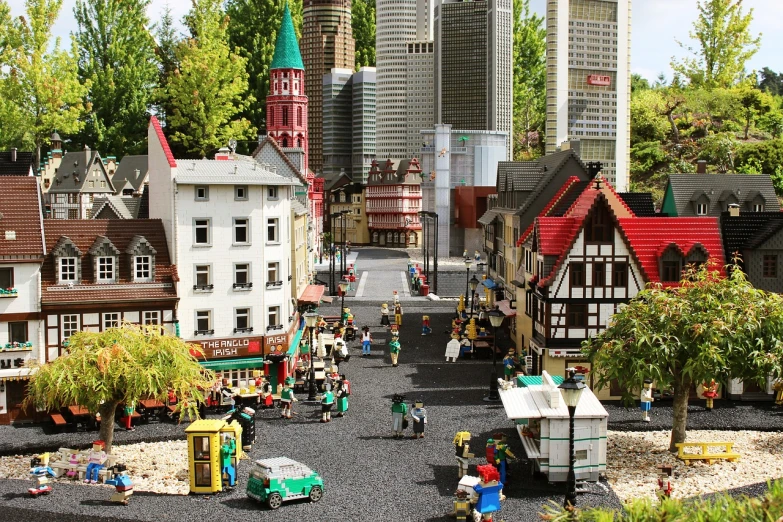 a model of a town with a lot of buildings, by Werner Gutzeit, shutterstock, lego set, germany. wide shot, dingy city street, city park