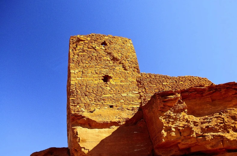 a tall brick tower sitting on top of a cliff, flickr, les nabis, new mexico with a yellow filter, ancient brass dwemer ruins, hoog detail, usa-sep 20