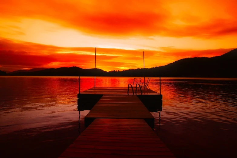 a dock in the middle of a lake at sunset, by James Warhola, shutterstock, fine art, coloured in orange fire, stock photo, vibrant red, big bear lake california