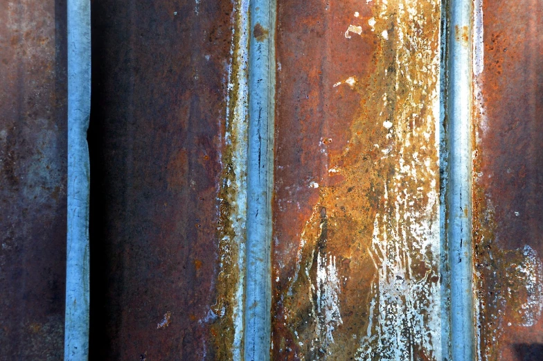 a close up of a rusted metal surface, by Richard Carline, flickr, lyrical abstraction, contrast side light, drainpipes, contrasting colours, rusted panels