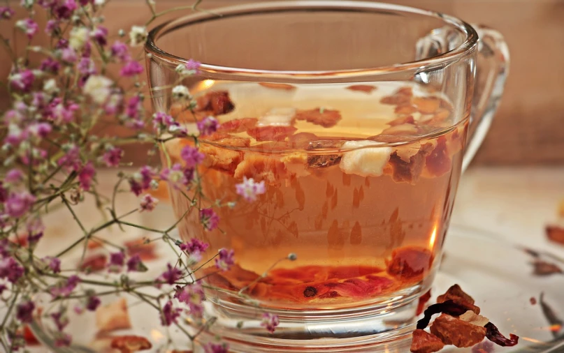 a cup of tea sitting on top of a table, inspired by Wlodzimierz Tetmajer, renaissance, dried flowers, aspic, square, healthy