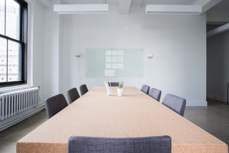 a long table with chairs and a vase on it, a picture, by Jan Kupecký, pexels, minimalism, whiteboard, table with microphones, grind, albuquerque