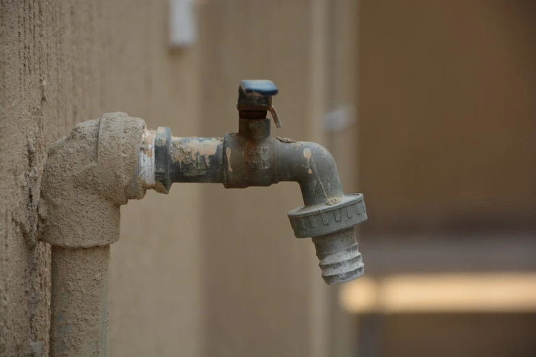 a close up of a water faucet on the side of a building, a tilt shift photo, partially covered with dust, maintenance photo, piping, islamic