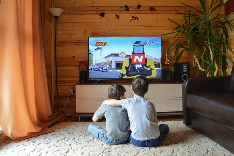 a couple of kids sitting in front of a tv, a cartoon, by Petr Brandl, pexels, nascar, cinematic view!!!, lego city, live action movie