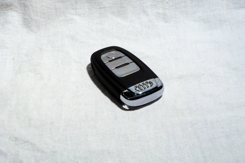 a close up of a cell phone on a white surface, by Adam Rex, minimalism, car shot, keys, kodak 2 5 0, dslr camera img_4016