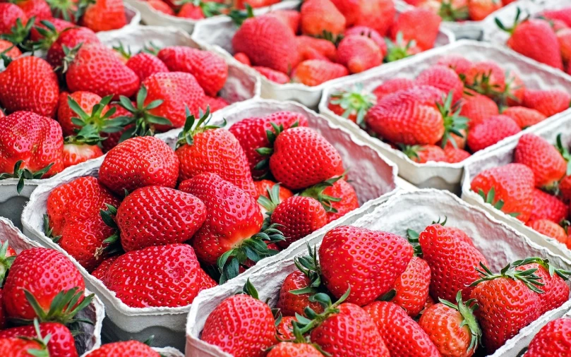 a close up of baskets of strawberries on a table, a photo, high quality product image”