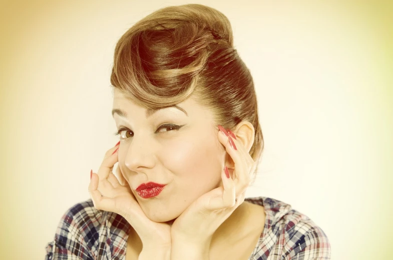 a woman posing for a picture with her hands on her face, inspired by Gil Elvgren, tumblr, rockabilly hair, vintage color photo, sideburns, ariana grande photography