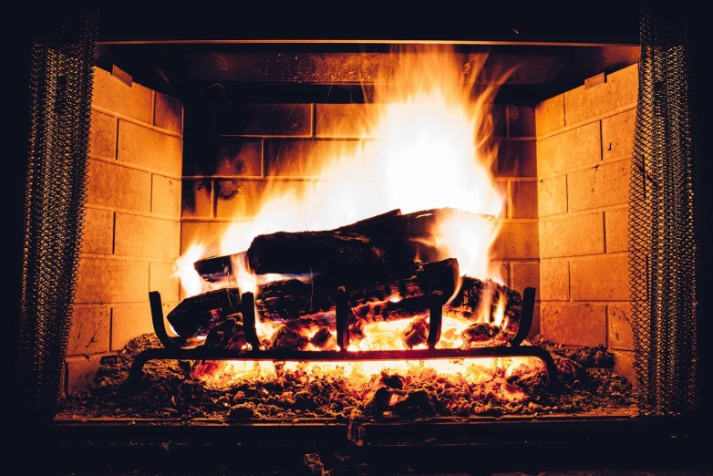 a close up of a fire in a fireplace, a picture, shutterstock, winter vibes, utah, inspiration, brightly-lit