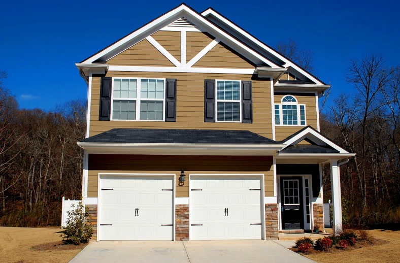 a two story house with a garage in front of it, by John Luke, pixabay, brown and white color scheme, gold and black color scheme, listing image, a middle-shot from front