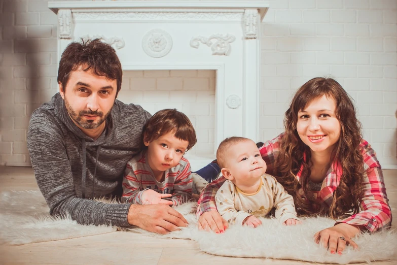 a family laying on the floor in front of a fireplace, a picture, by Alexander Fedosav, shutterstock, looks at the camera, avatar image, high detail portrait photo, istockphoto