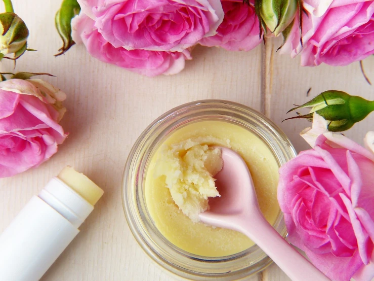 a jar of body butter next to pink roses, by Arabella Rankin, pexels, process art, mustard, natural lips, chiffon, homemade