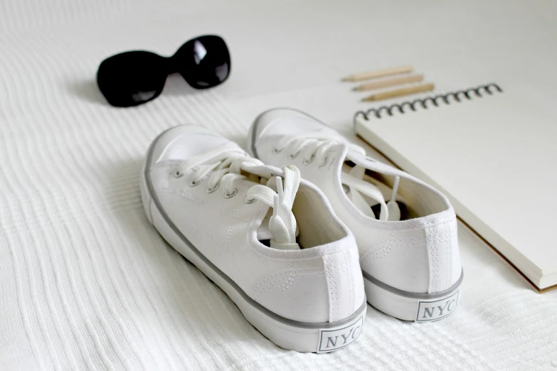 a pair of white shoes sitting on top of a bed, a picture, tumblr, hot summer sun, gray canvas, high - end, : 5 stylish