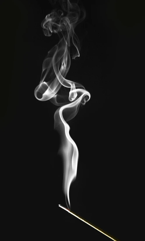 a cigarette with smoke coming out of it, a black and white photo, inspired by Robert Mapplethorpe, pexels, art photography, swirls of fire, ghostly figure, incense, marijuana photography