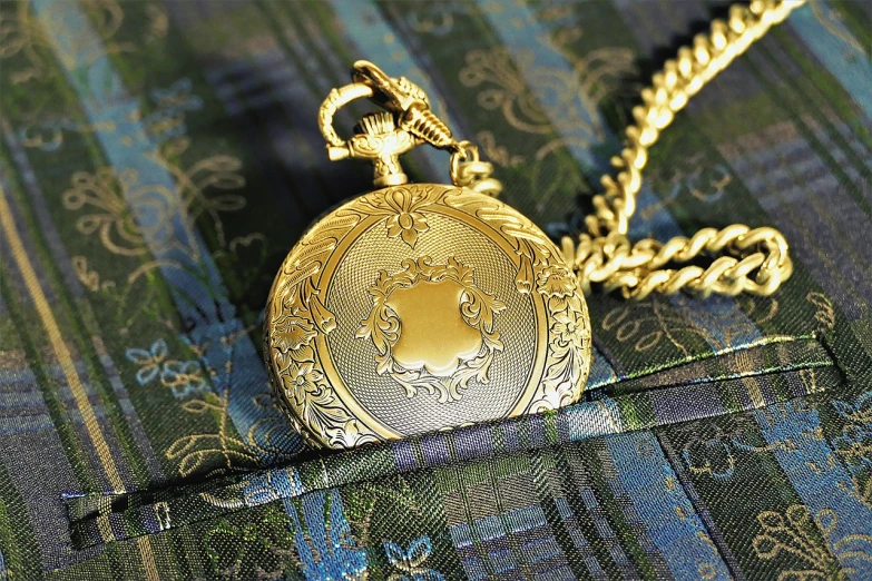 a close up of a pocket watch with a chain, inspired by Ralph Horsley, art nouveau, gold cloth, high detailed photo, highly detailed product photo, gold clothes
