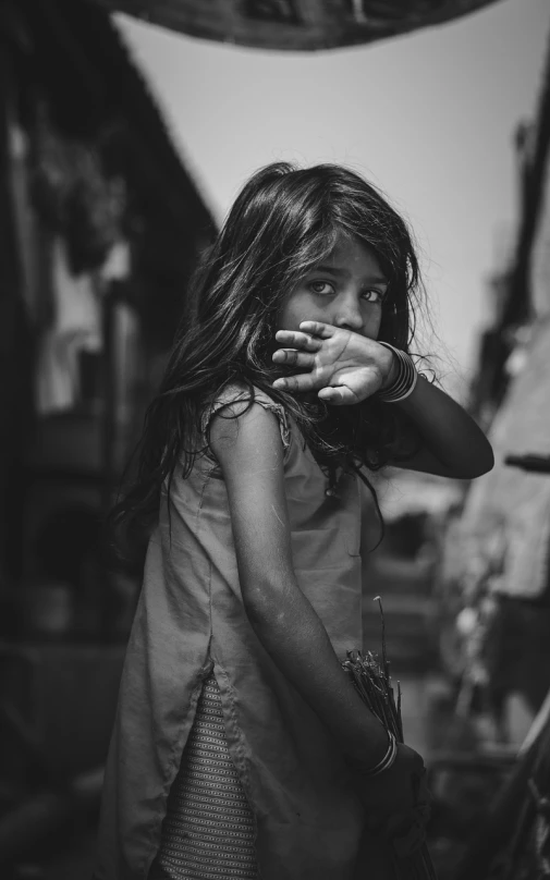 a black and white photo of a little girl, by Ibrahim Kodra, pexels contest winner, on an indian street, finger, attractive girl, hunger