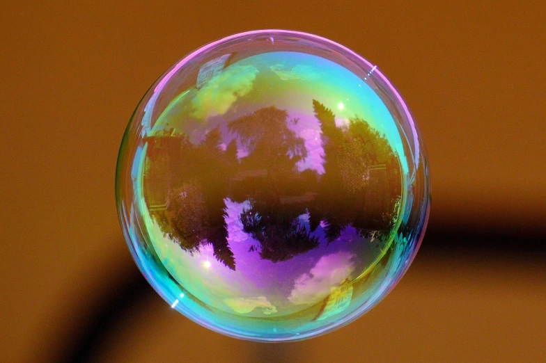 a close up of a soap bubble on a table, by Jan Rustem, flickr, precisionism, rainbow gradient reflection, tree of life inside the ball, bubblegum pop, gold green blue purple