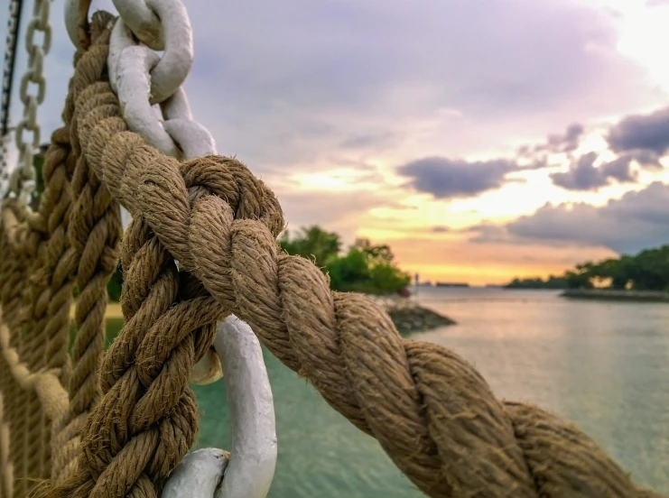 a close up of a rope on a boat, a picture, by Anna Haifisch, unsplash, post processed 4k, large chain, sunset view, hdr smooth