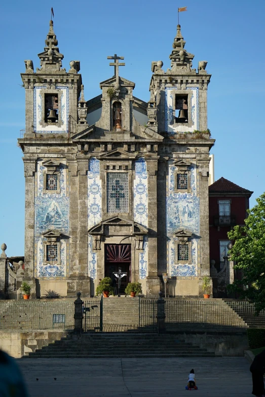 a large building with a clock on the front of it, by Juan Giménez, baroque, azulejo, churches, set photo, tape