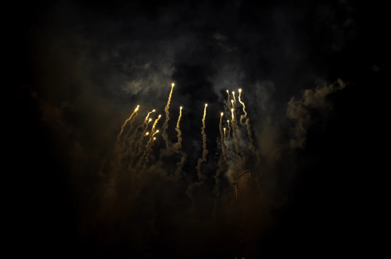 a bunch of fireworks that are in the sky, by Géza Dósa, flickr, hurufiyya, ashes and smoke columns, dramatic lighting from below, tear gas, photography