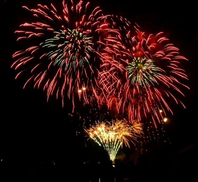 a group of fireworks lights up the night sky, 1786560639, red and teal and yellow, ( visually stunning, vibrant red and green colours