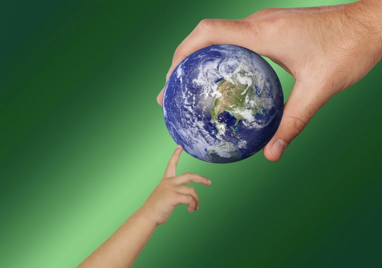 a person holding a small child's hand in front of the earth, a photo, digital art. photo realistic, a green, 2 0 1 0 photo, god\'s creation