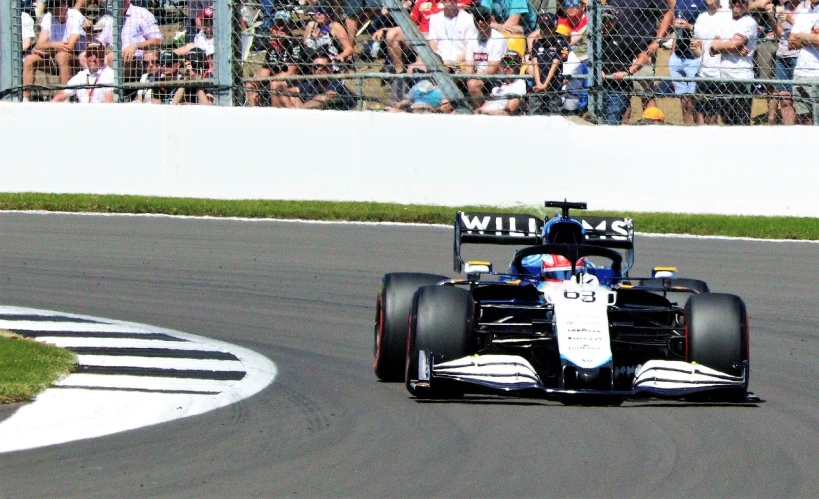 a man driving a race car down a race track, a picture, inspired by Sam Dillemans, flickr, white and blue, f 1 driver charles leclerc, photo taken in 2 0 2 0, chesterfield