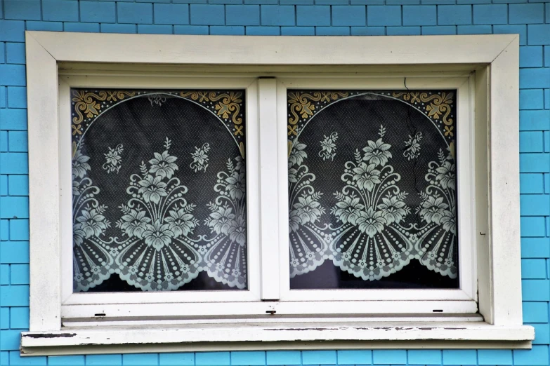 a close up of a window on a blue building, a silk screen, by Karl Völker, flickr, art nouveau, dressed in white intricate lace, twins, nineteenth century, paint-on-glass painting