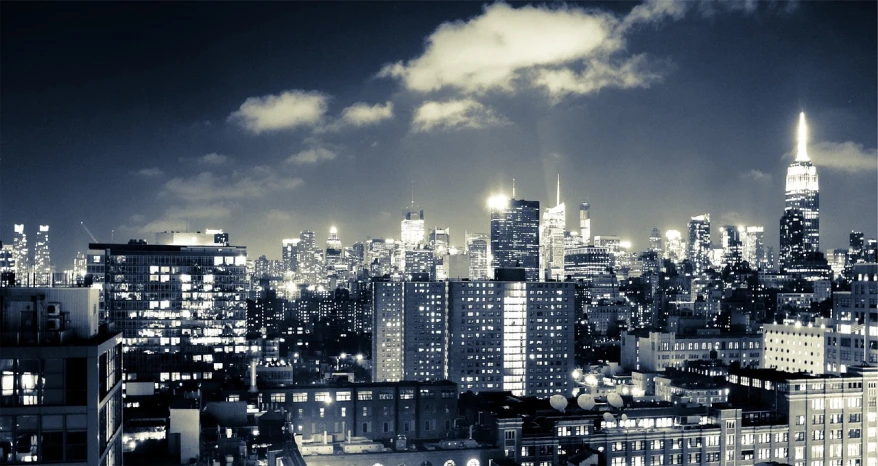 a black and white photo of a city at night, flickr, new york background, heaven on earth, slide show, brightly-lit