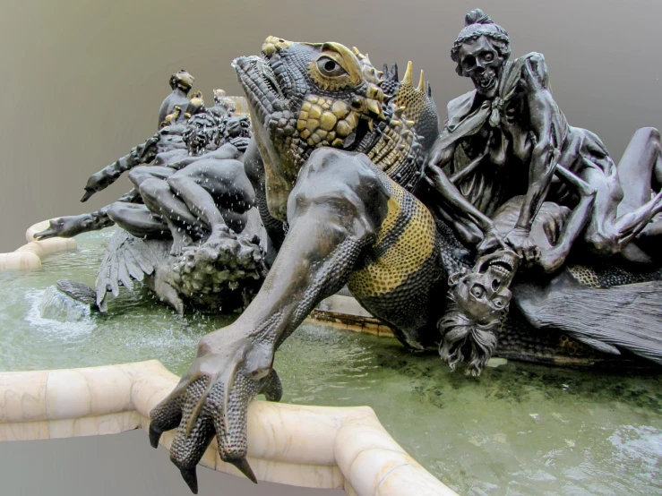 a statue of a dragon sitting on top of a fountain, a statue, inspired by Sir Jacob Epstein, flickr, baroque, as atlantean reptilian warriors, very accurate photo, iguana, view from the bottom