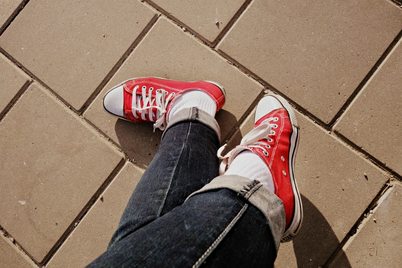 a close up of a person wearing red sneakers, by Matija Jama, rock star, sunny day, red and white, realistic photo