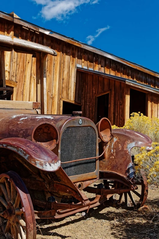 an old car is parked in front of a barn, by Jim Nelson, shutterstock, on the desert, detailed zoom photo, on a sunny day, usa-sep 20