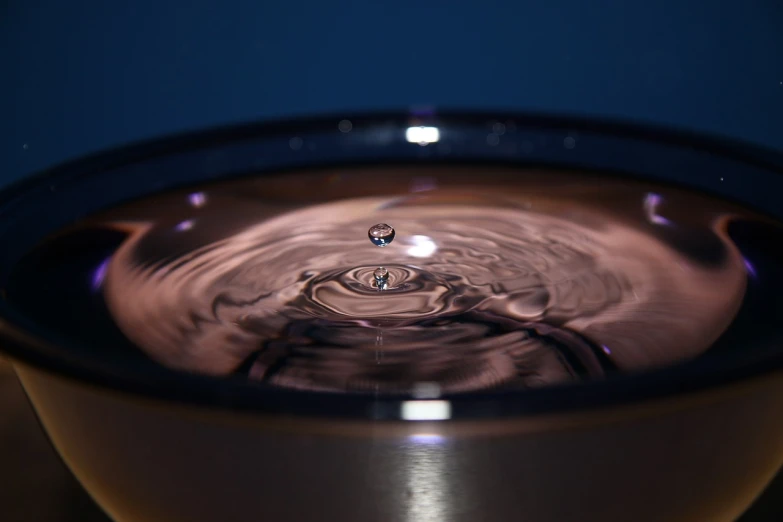 a close up of a water drop in a bowl, by Jan Rustem, flickr, holography, rippling electromagnetic, short dof, bubbly, by greg rutkowski
