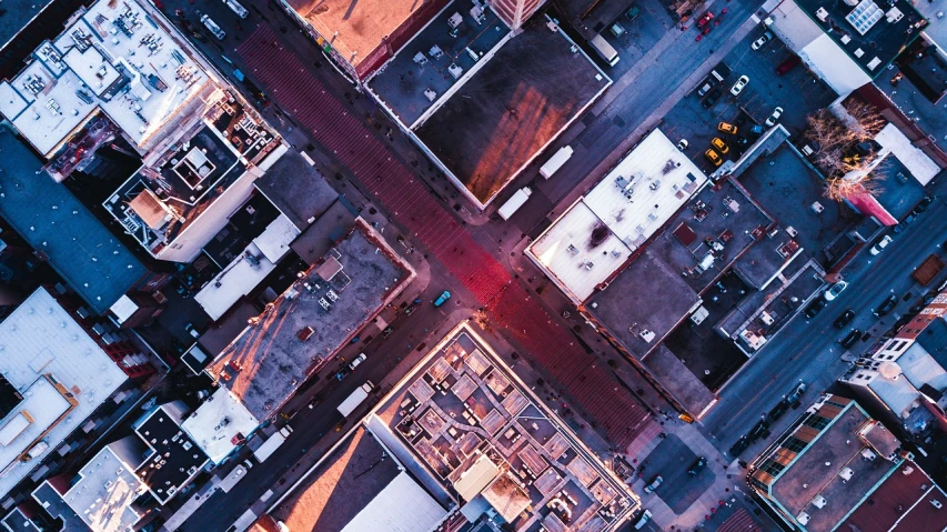 an aerial view of a city street at night, by Dan Christensen, hot sun from above, cross composition, reddish, square