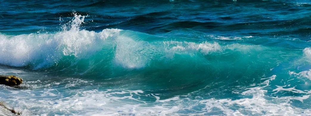 a man riding a wave on top of a surfboard, a picture, pixabay, fine art, aquamarine, [bioluminescense, a close-up, waves crashing in the sea