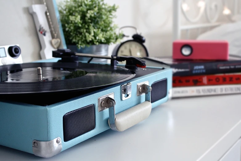 a record player sitting on top of a white table, an album cover, by Maksimilijan Vanka, shutterstock, light blues, highly detailed close up shot, speakers, high details!