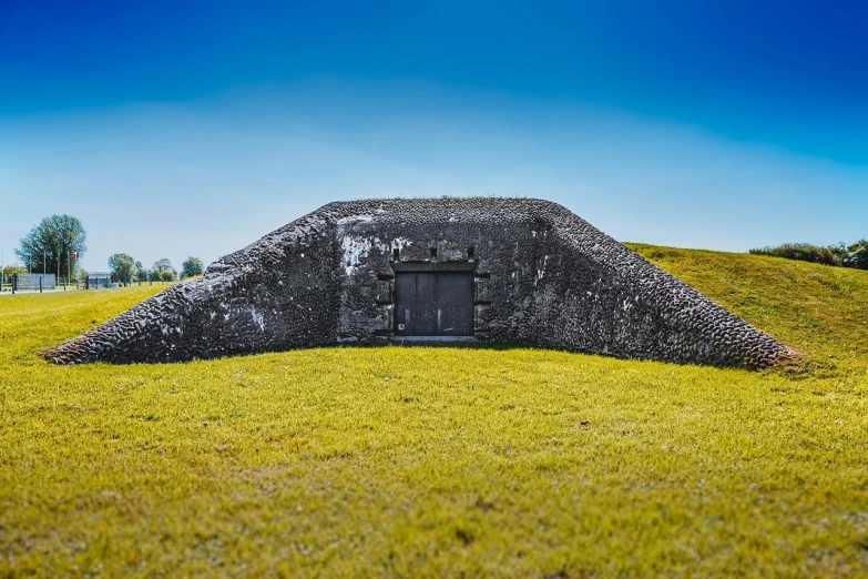 a bunker sitting on top of a lush green field, folk art, in an ancient tomb, museum quality photo, azores, extremely detailed photo