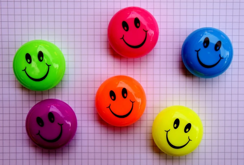 a group of smiley faces sitting on top of a table, a picture, pexels, happy colors dariusz zawadzki, ((neon colors)), good day, full of colour 8-w 1024