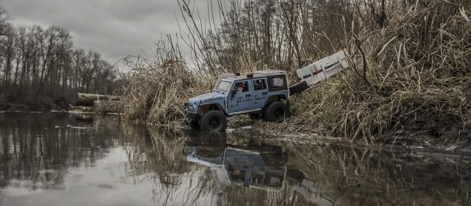 a truck that is sitting in some water, a portrait, cg society contest winner, jeep wrangler, scale model photography, on a riverbank, “erebos’s titan