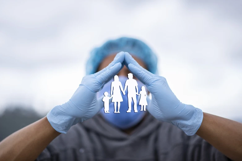 a person in blue gloves holding a paper cutout of a family, a stock photo, symbolism, masked doctors, super detailed picture, perfect structure, all enclosed in a circle