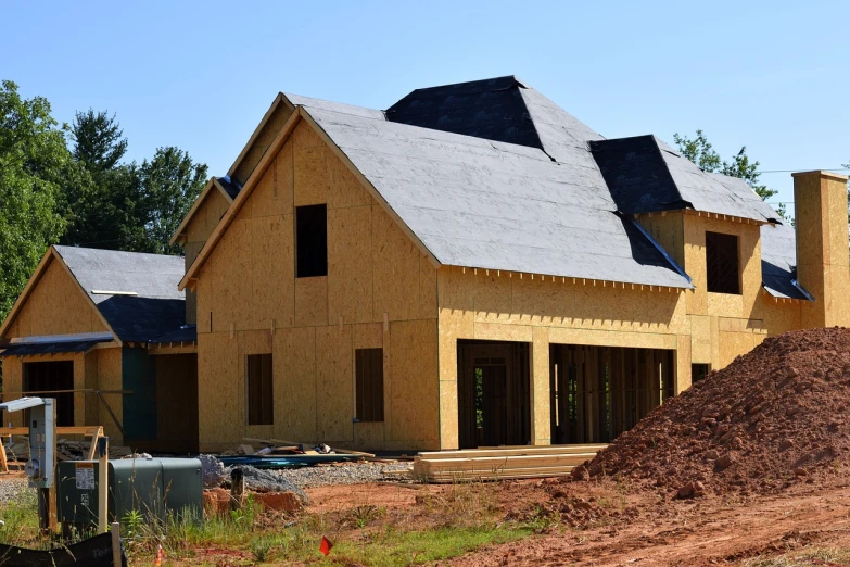 a house under construction with a pile of dirt in front of it, shutterstock, black roof, side view, stock photo, soft top roof raised