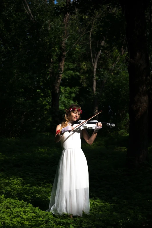 a woman in a white dress playing a violin, inspired by Konstantin Somov, shutterstock, evening!! in the forest, photo taken with sony a7r, midsommar style, wedding