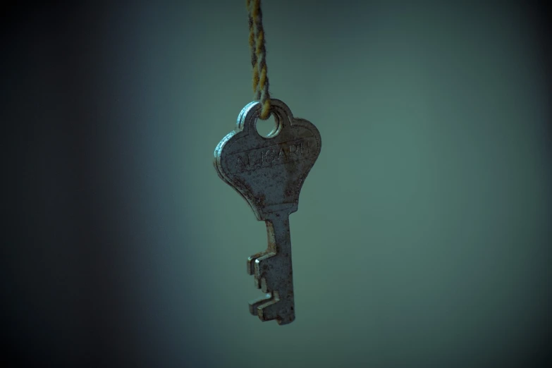 a close up of a key hanging from a rope, a digital rendering, by Jesper Knudsen, pexels, low quality 3d model, low key, old, iray