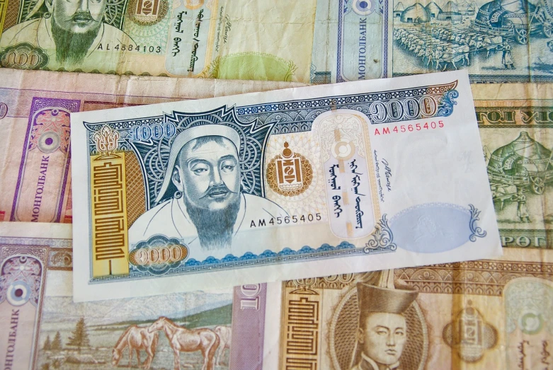 a pile of money sitting on top of a table, a portrait, dau-al-set, chinese mongolian script, arab man light beard, very very well detailed image, cyangmou