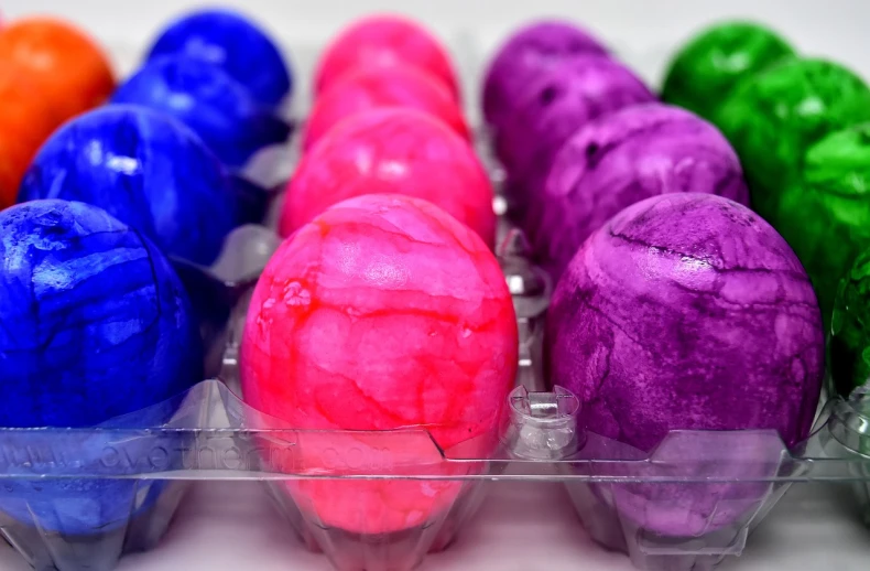 a tray of colored eggs sitting on top of a table, process art, made of alcohol ink on parchment, vivid ultraviolet colors, high res photo, rich bright sunny colors