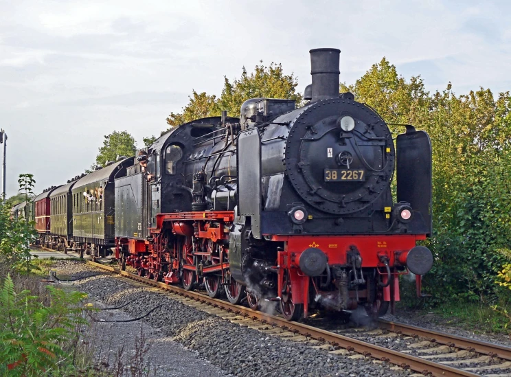 a black and red train traveling down train tracks, by Jörg Immendorff, preserved historical, cp2077, big engine, full subject shown in photo