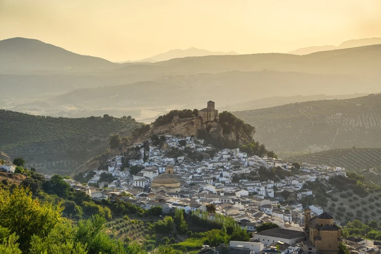 a view of a town from the top of a hill, by Altichiero, shutterstock, dau-al-set, early morning, castle on the mountain, juan jose serrano, corona